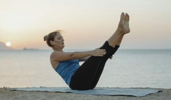 Woman at the Beach Doing Yoga