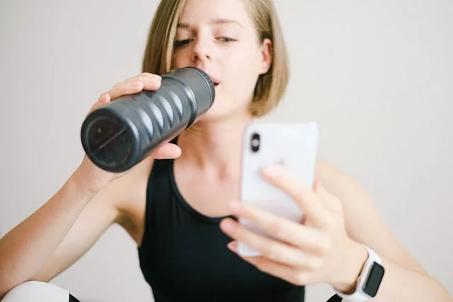 Woman drinking plenty of water after exercise