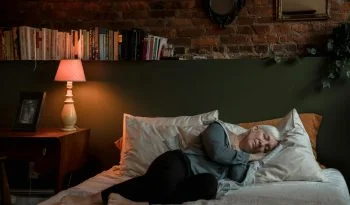An Elderly Woman Sleeping Peacefully on Her Bed